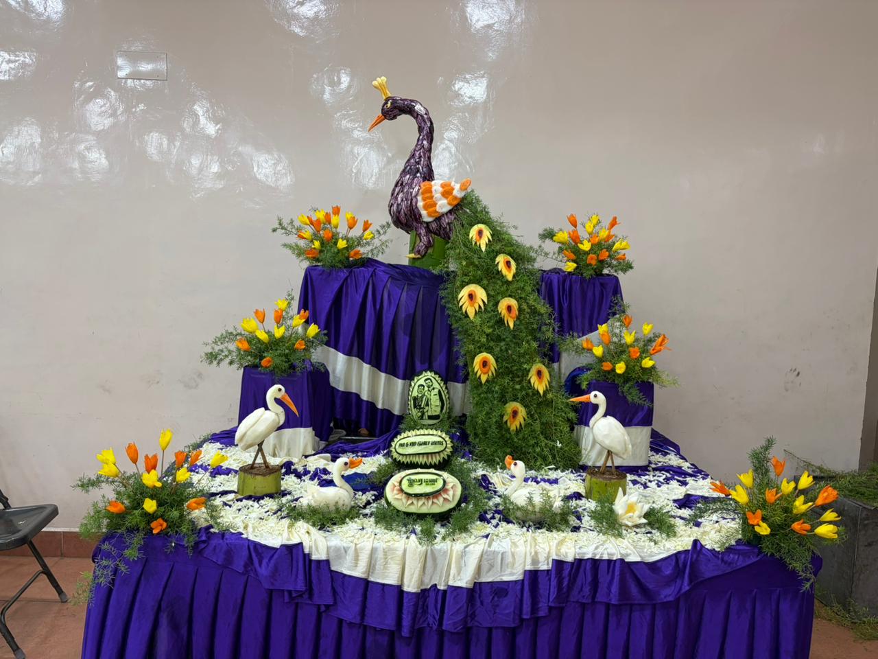 Peacock-themed wedding decor with flowers and table styling